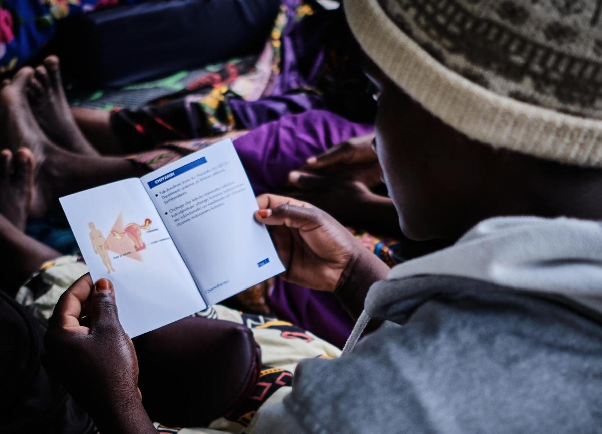Une patiente feuillette un livret d'information sur la chimiothérapie. Malawi. 2022.
 © DIEGO MENJIBAR